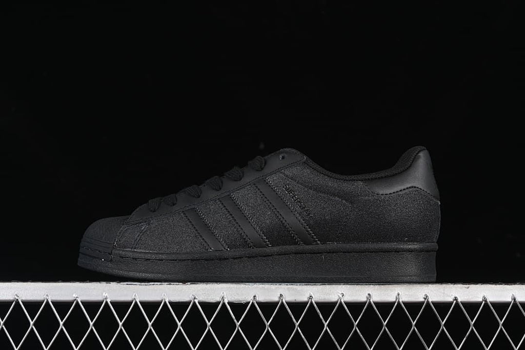 Side view of black adidas Superstar EG4961 low-top sneaker