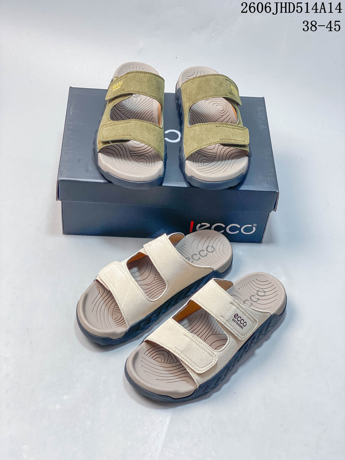 Olive green and cream two-strap sandals displayed together with their box.