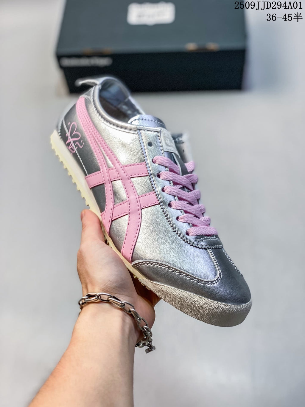 Angled view of the silver sneaker, pink side stripes, and light outsole