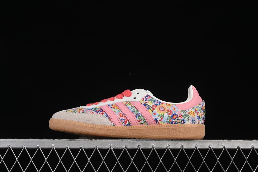 Side view of floral adidas Samba OG sneakers with pink stripes, coral laces and gum outsole.