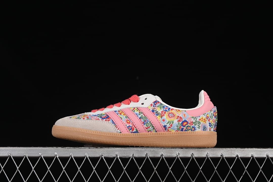 Side view of floral adidas Samba OG sneakers with pink stripes, coral laces and gum outsole.