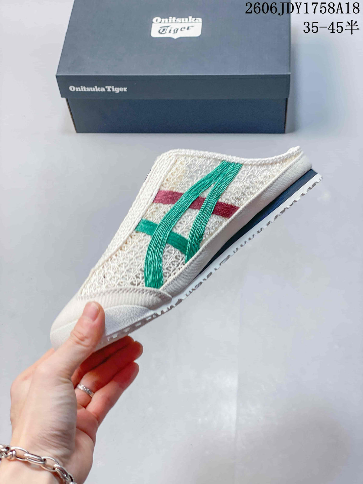 Side view of a cream Onitsuka Tiger Sabot slip-on with green and red stripes