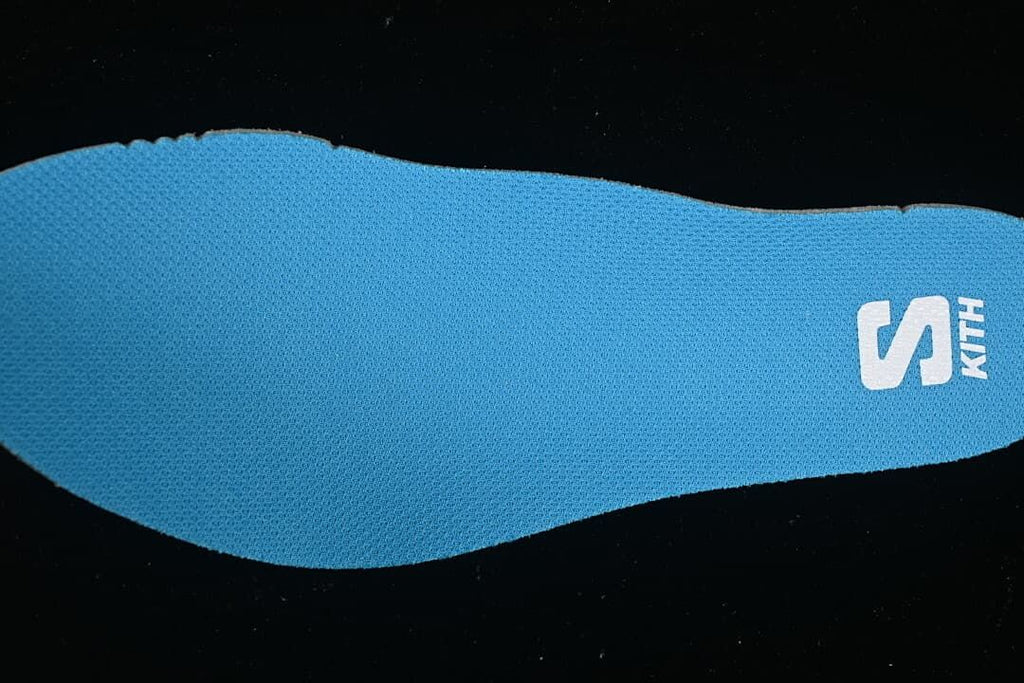 Blue footbed with Salomon logo shown close up