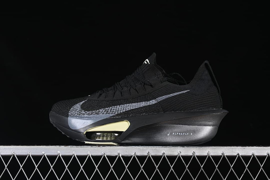 Side view of black Nike Alphafly 3 running shoe with silver Swoosh and pale yellow sole accents