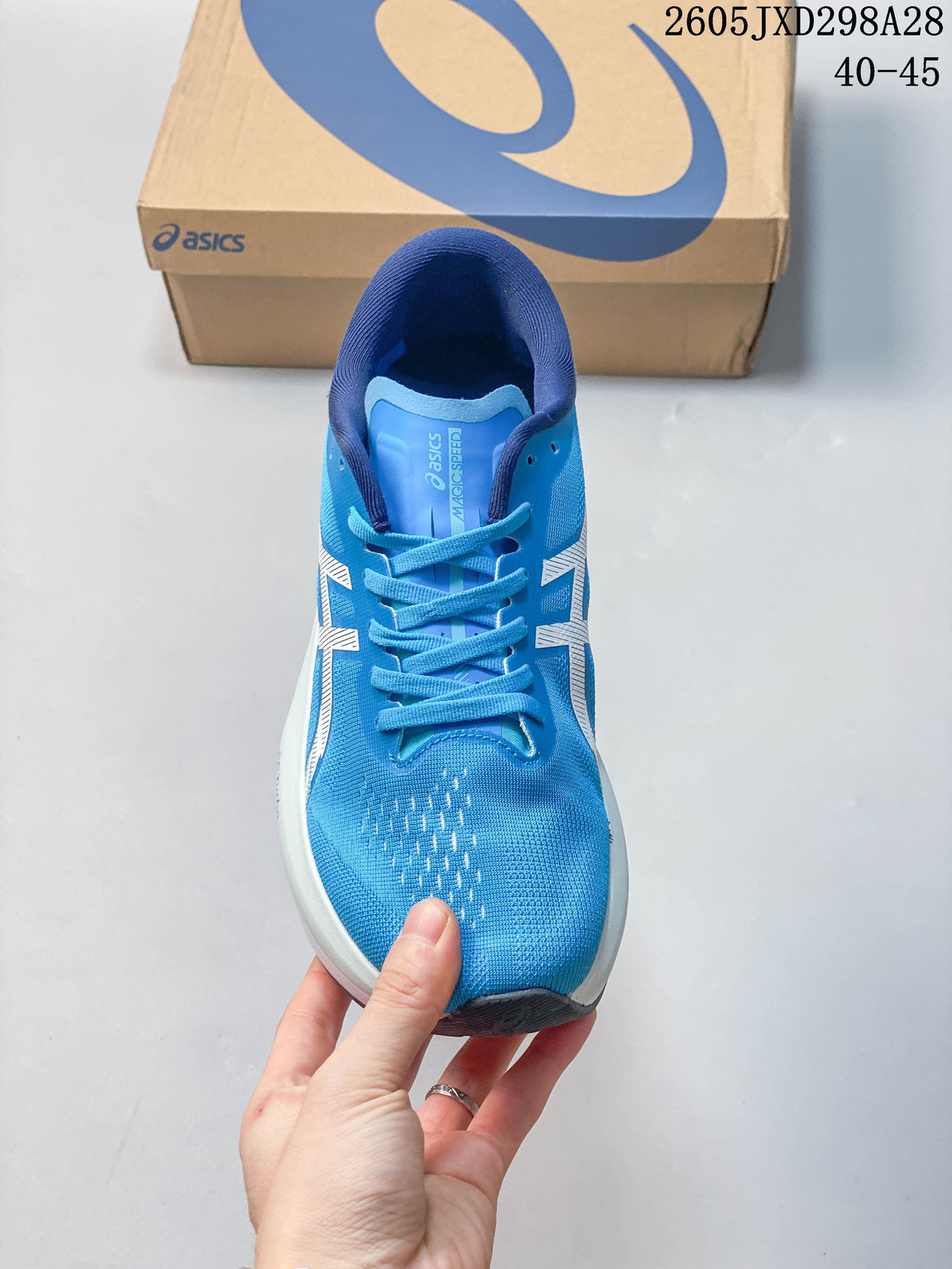 Front view of a blue ASICS Magic Speed 4 shoe with laces
