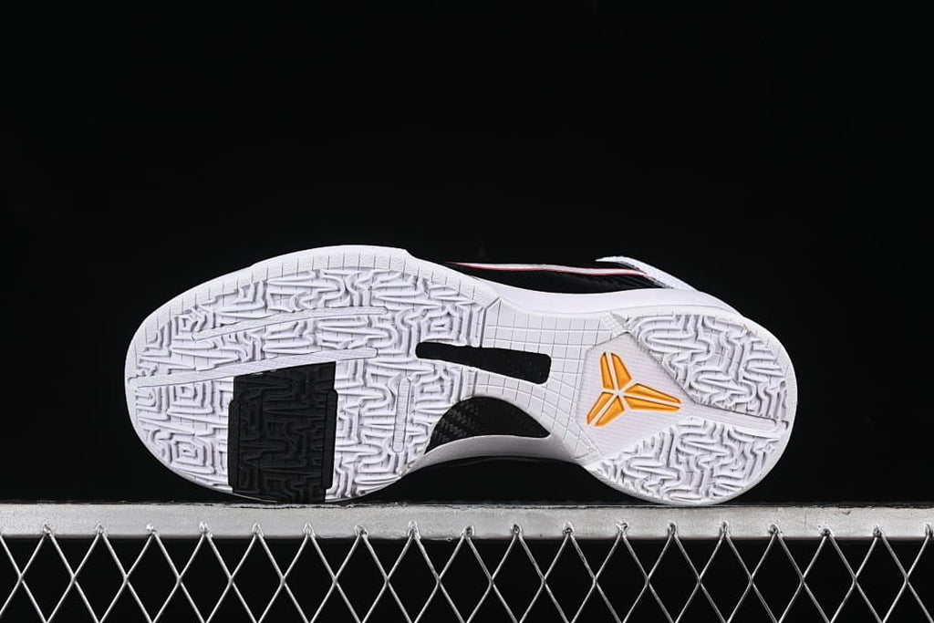 Outsole view showing patterned traction and yellow Kobe logo