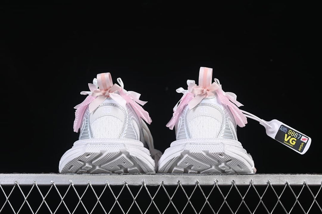 Rear view of both sneakers highlighting the heels and outsole shape.