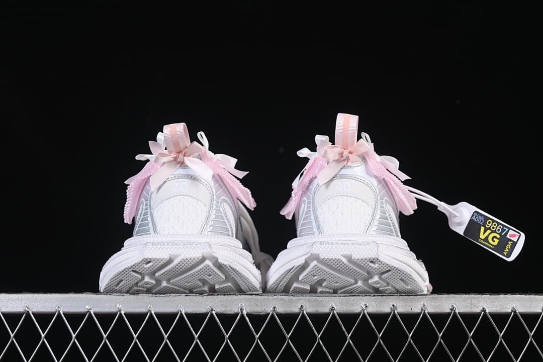 Rear view of both sneakers highlighting the heels and outsole shape.