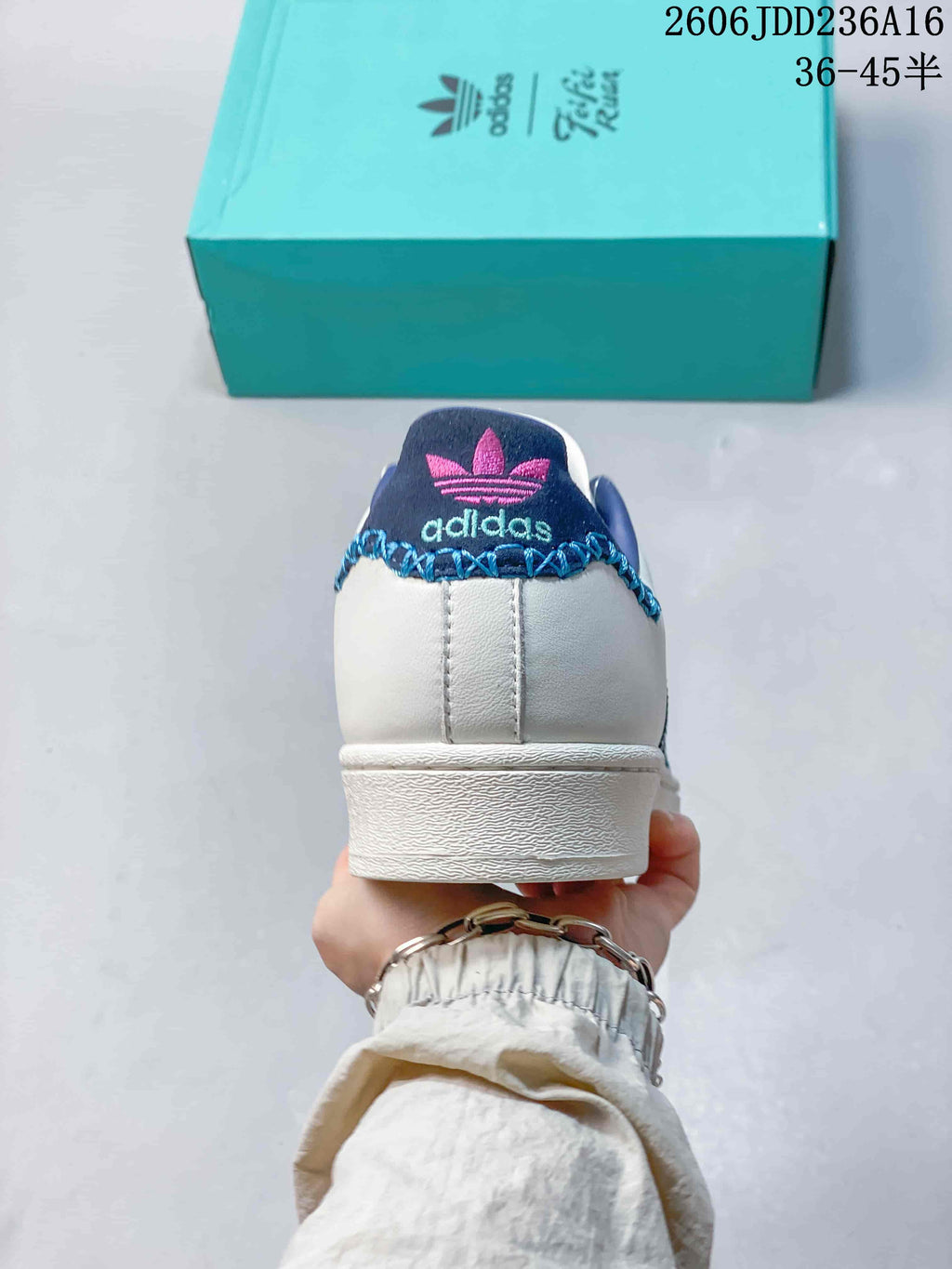 Rear view showing the white heel, blue collar, and Adidas branding.