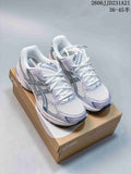 Pair of white ASICS GEL-1130 sneakers with silver and lavender accents on a shoebox