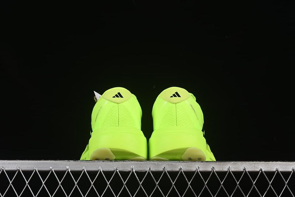 Rear view of the pair of neon yellow shoes.