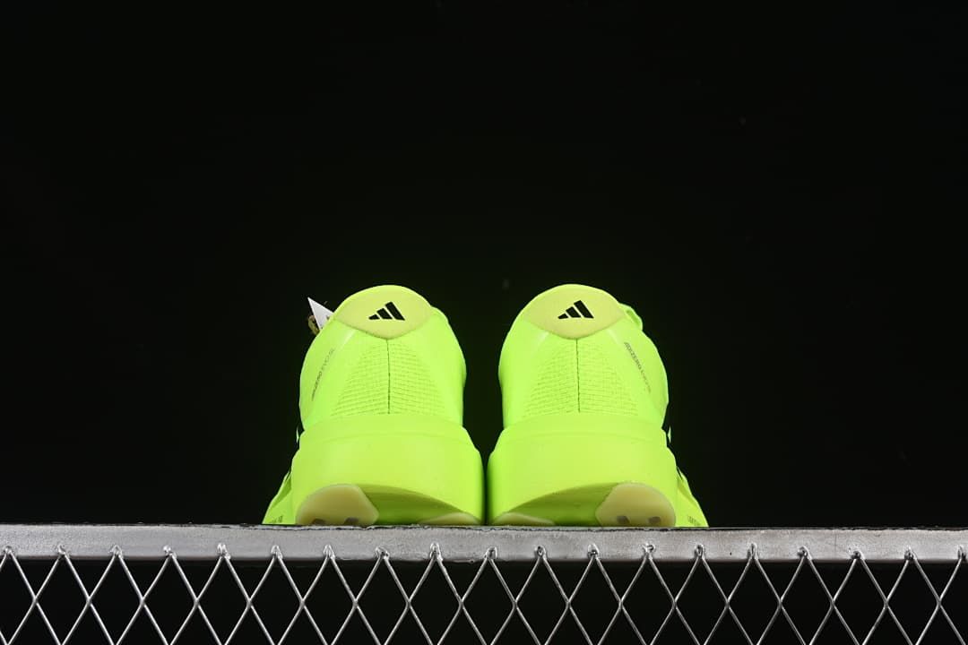Rear view of the pair of neon yellow shoes.