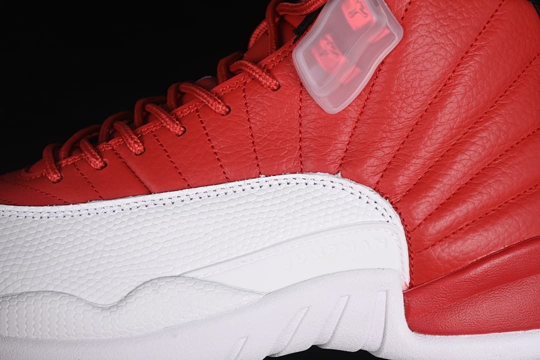 Close-up of the red upper, white mudguard, and lace hardware