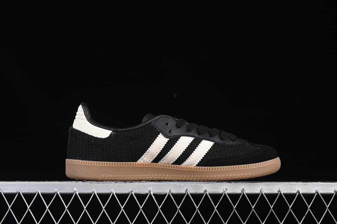 Side profile of a black Samba OG sneaker with white stripes and gum-colored outsole