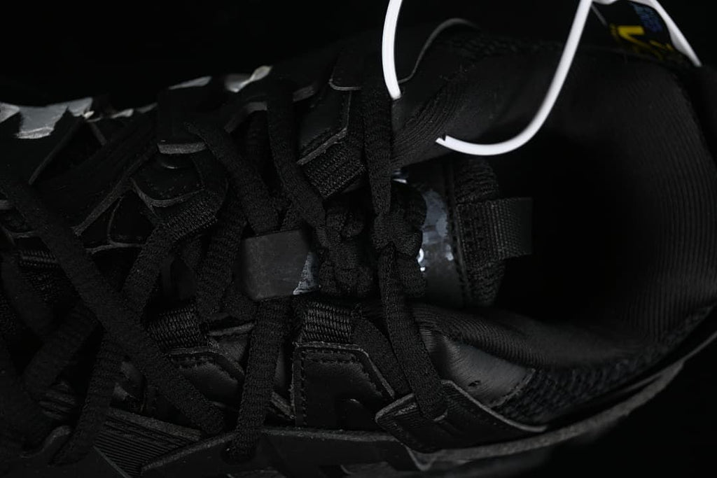 Top-down detail of black laces and the shoe interior.
