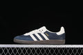 Side view of a navy and cream adidas Samba OG sneaker with a dark outsole