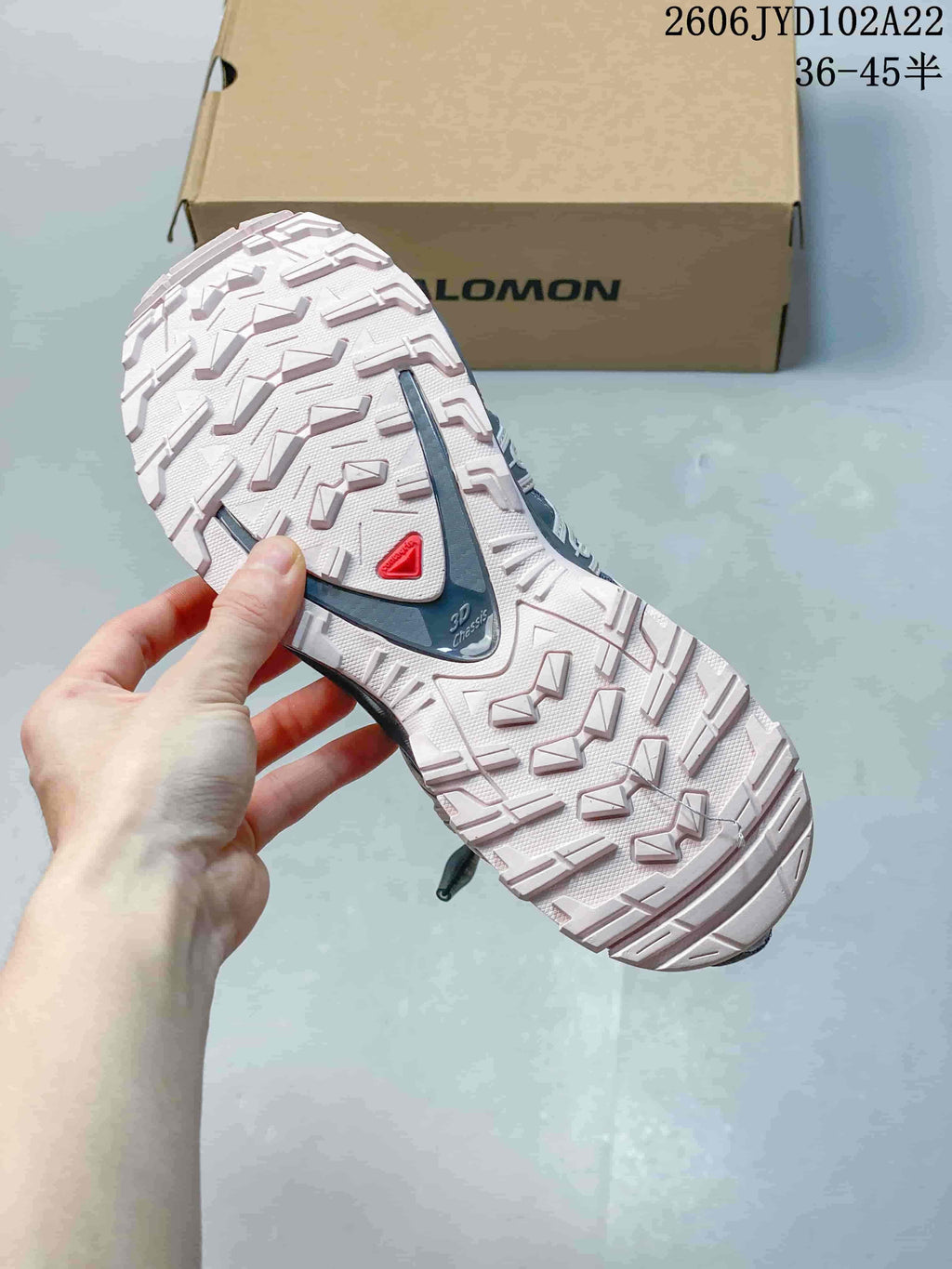 Close view of the patterned outsole and heel section of a Salomon shoe