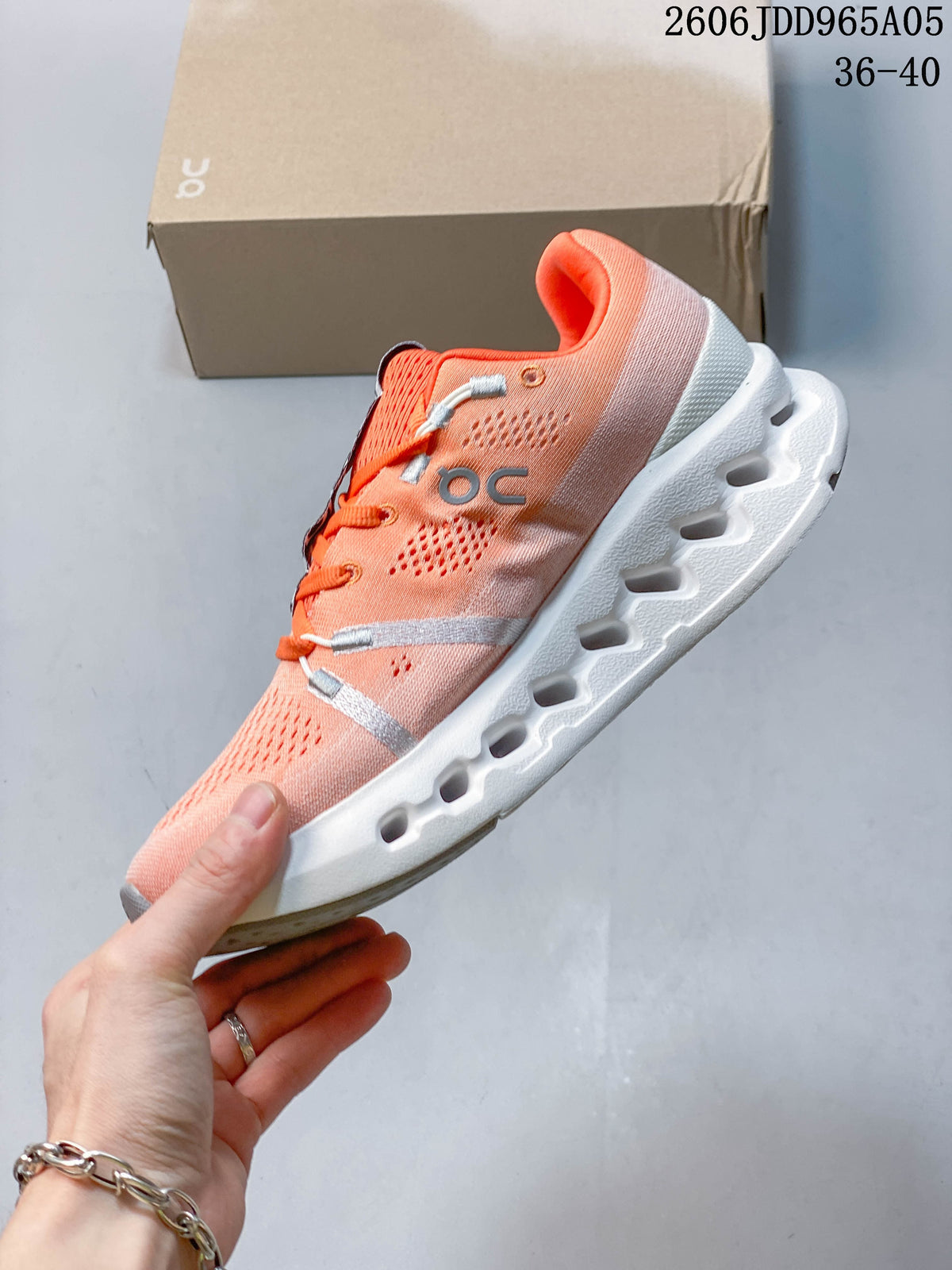 Side view of a coral On Cloudsurfer Trail shoe with a sculpted white sole
