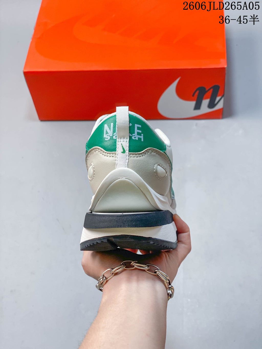 Rear view of the off-white and green Nike x sacai LDWaffle sneaker.