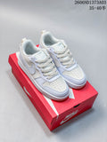 Pair of white and pale blue Nike Court Borough Recraft low-top sneakers on a red Nike box