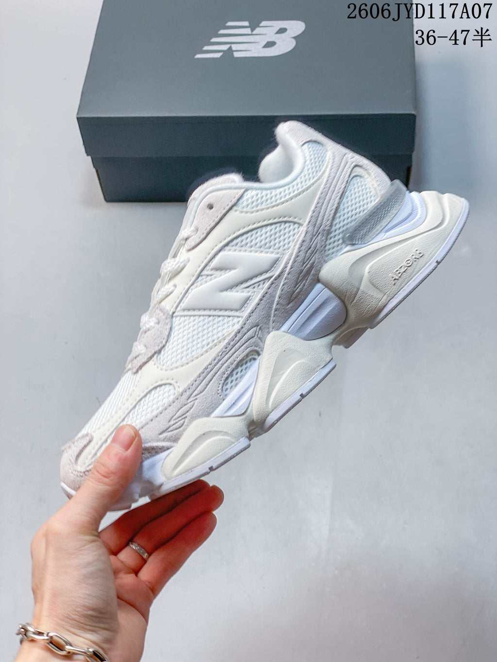 Side profile showing layered panels and sculpted sole on a New Balance 9060 sneaker