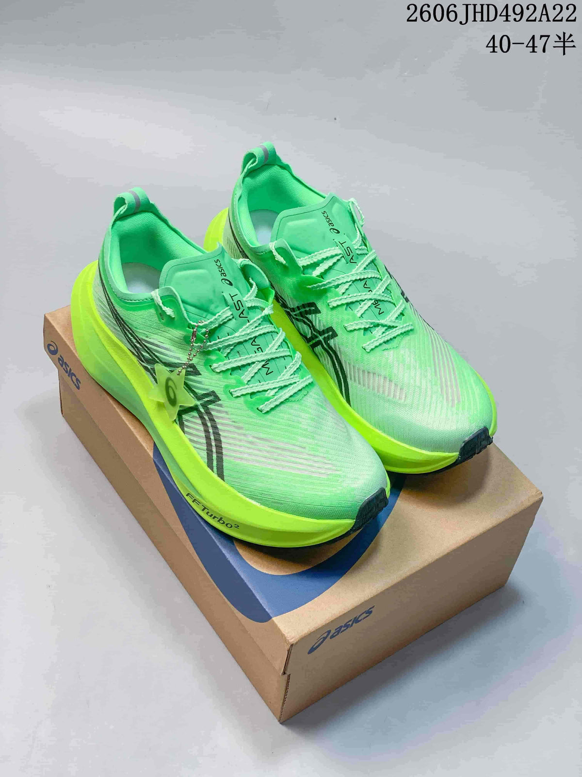 Bright green ASICS MEGABLAST shoes on a shoebox