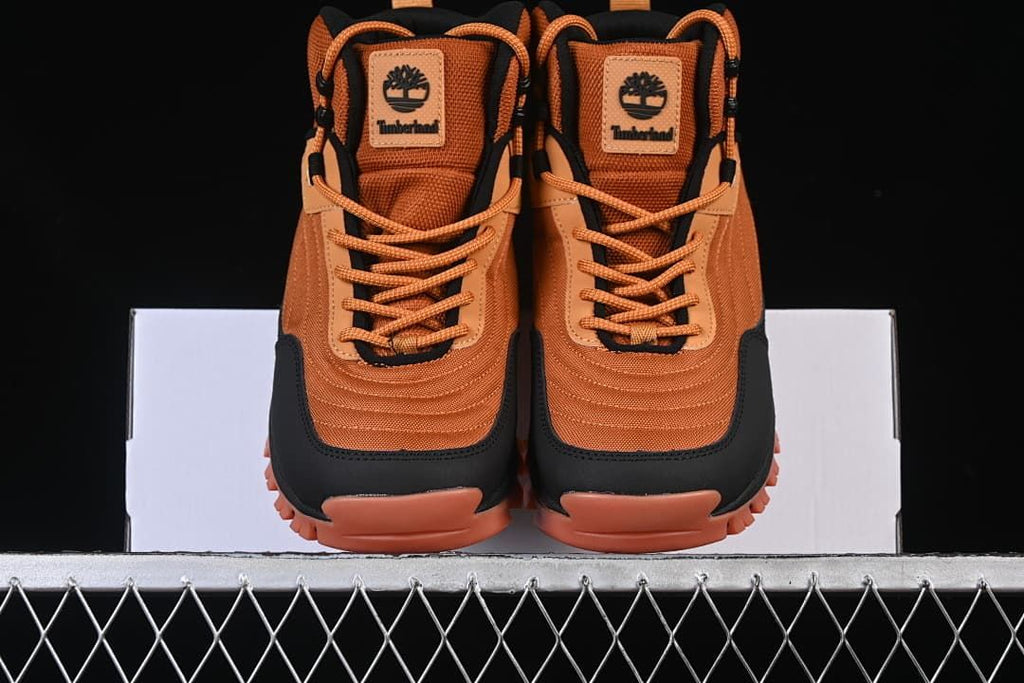 Front view of the pair showing the laces, toe overlays, and lugged soles