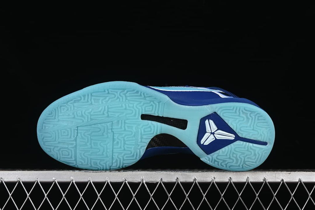 Bottom view showing aqua outsole tread and central shoe detail
