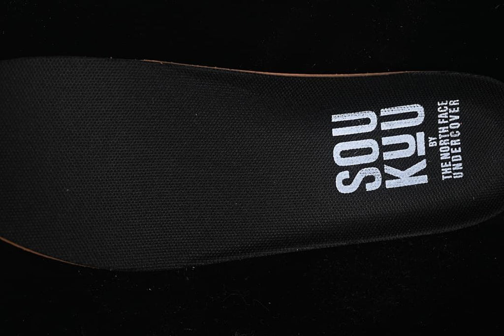Close-up of black insole with printed co-branding
