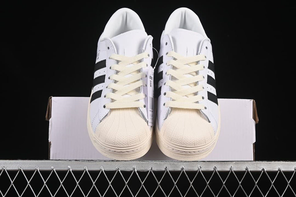Front view of the pair showing the textured shell toes and cream laces