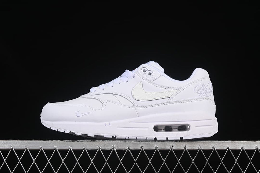 Side view of a white Nike Air Max 1 sneaker with a visible heel Air unit
