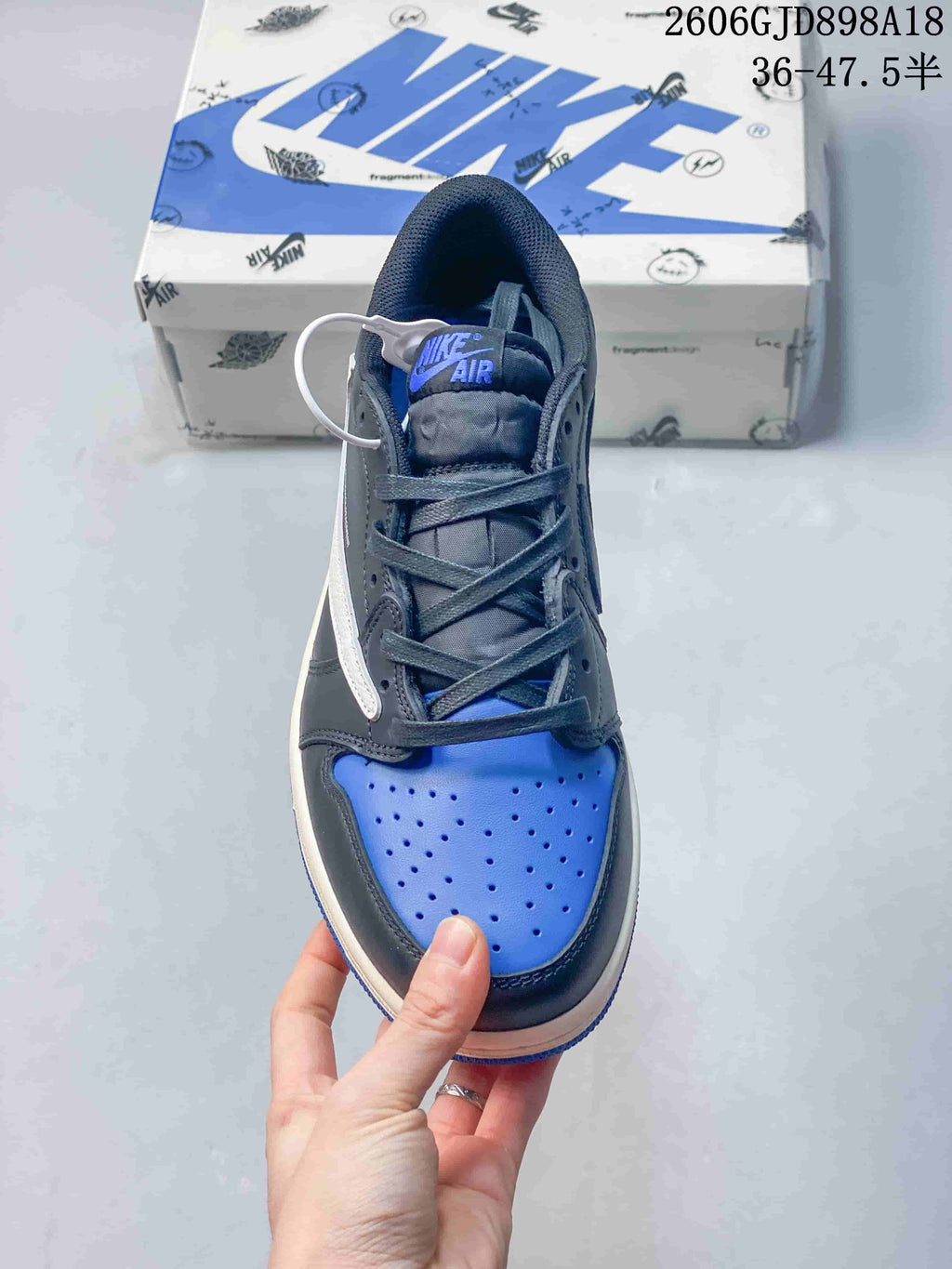 Top view of the sneaker showing blue perforated toe and dark laces