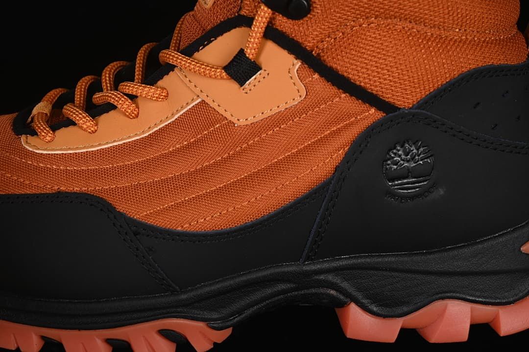 Close-up of the orange upper, black overlay, and side logo