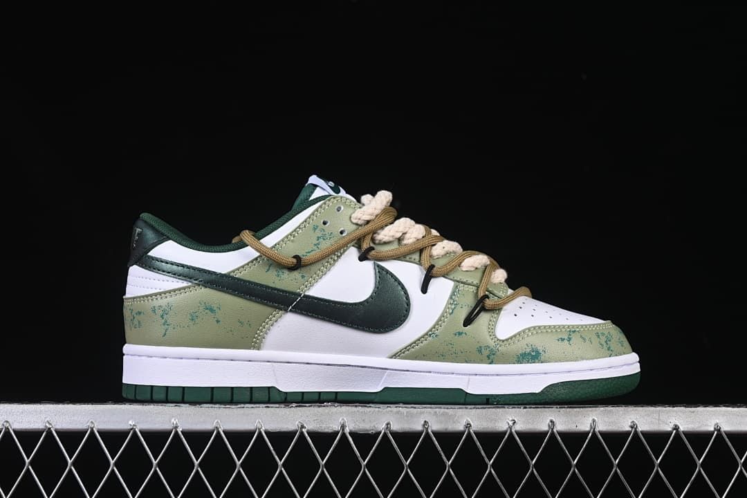 Side profile of a white and green low-top sneaker
