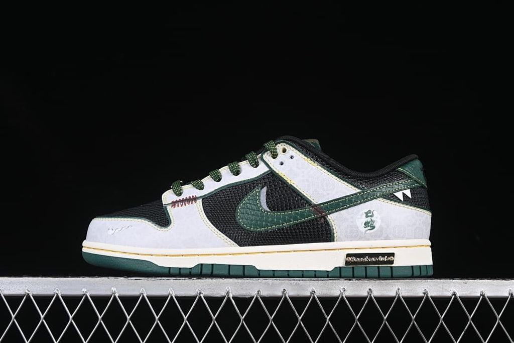 Side view of black, white, and dark green Nike SB Dunk Low shoes with patterned overlays and green accents
