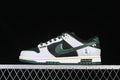 Side view of black, white, and dark green Nike SB Dunk Low shoes with patterned overlays and green accents
