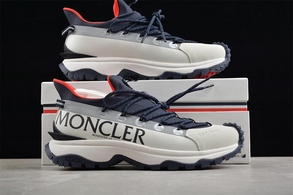 Trailgrip Lite2 sneaker displayed in front of its box.