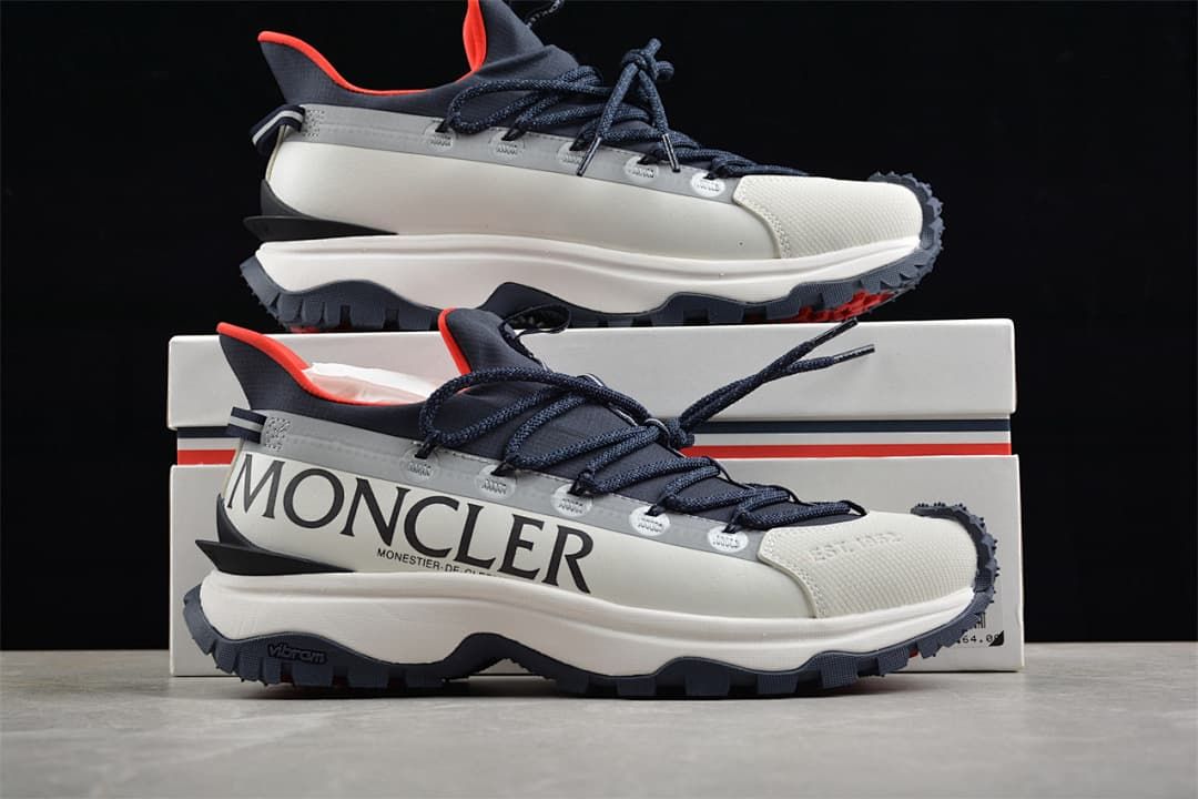 Trailgrip Lite2 sneaker displayed in front of its box.