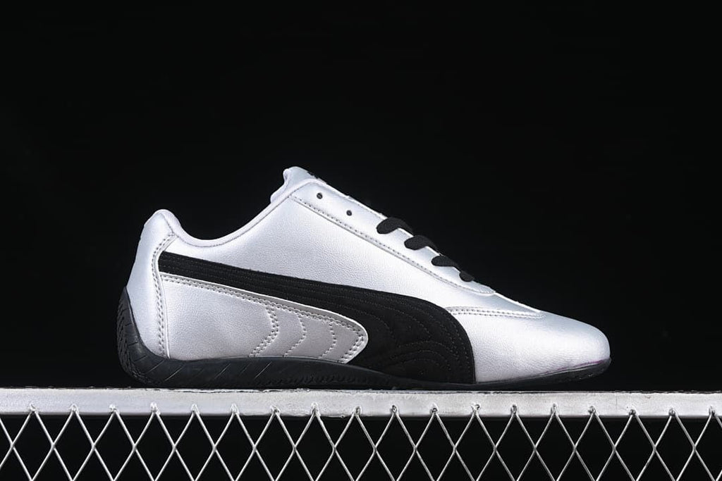 Side profile of the silver and black low-top Puma Speedcat OG sneaker.