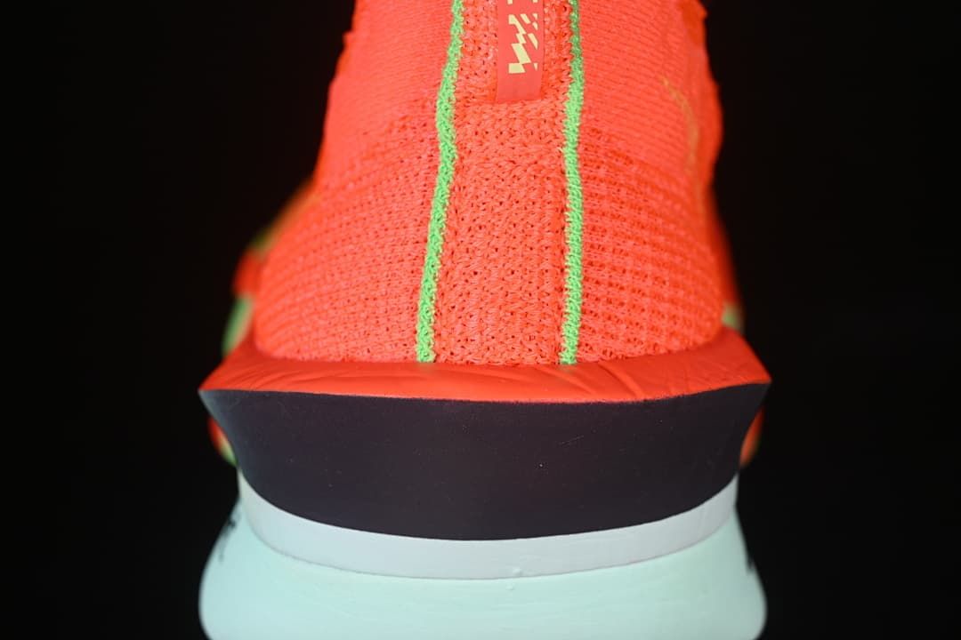 Rear view showing the knit heel, lime trim and pale mint midsole.