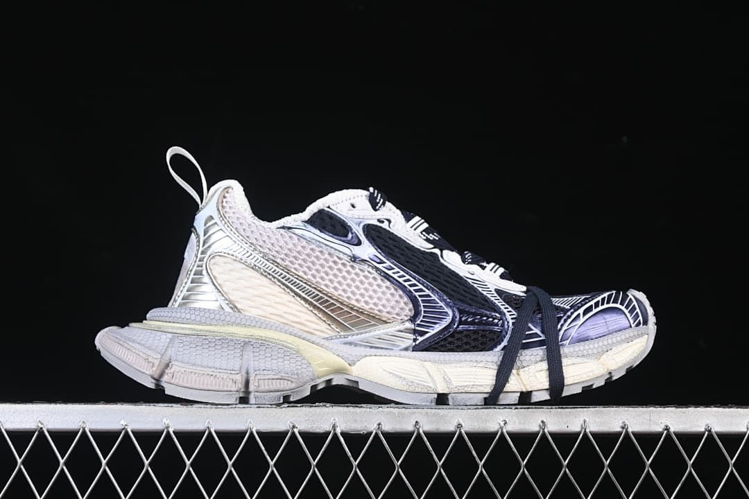 Side profile of one sneaker showing the layered panels and chunky sole.