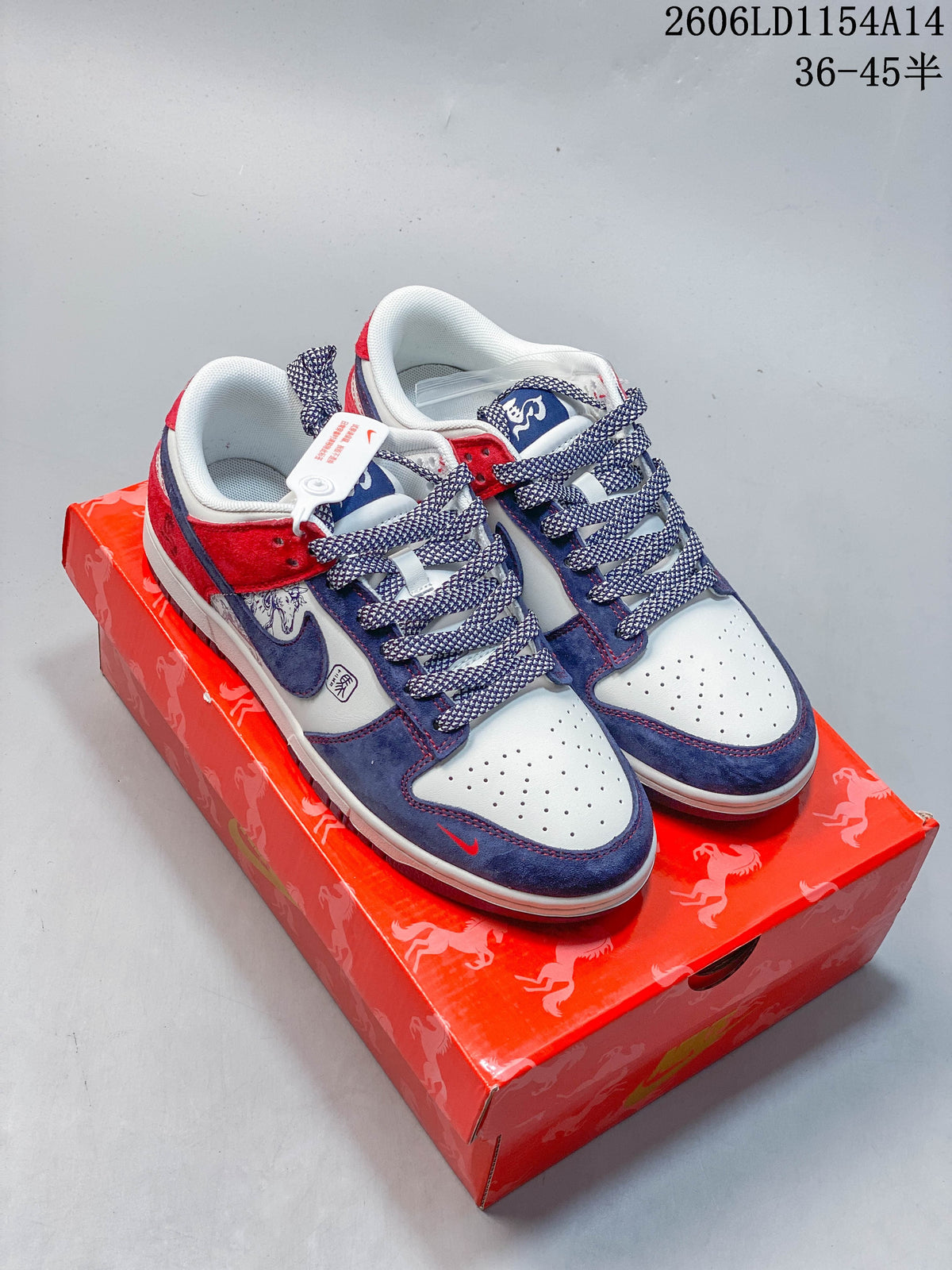 Pair of red, white, and blue Nike SB Dunk Low sneakers shown on a red patterned shoebox