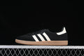 Side view of a black adidas Samba OG sneaker with white stripes and a gum-colored outsole