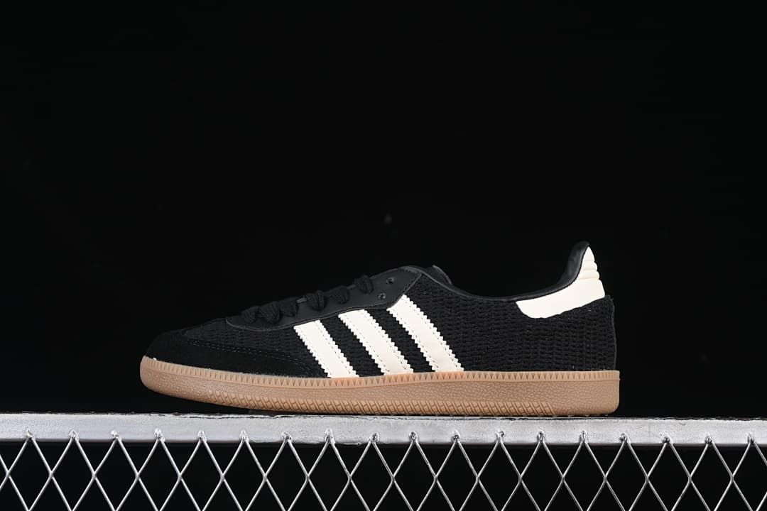 Side view of a black adidas Samba OG sneaker with white stripes and a gum-colored outsole