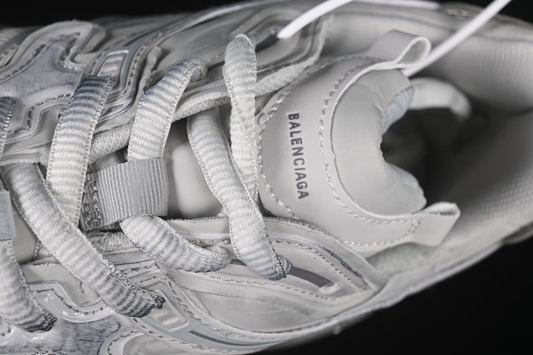 Top detail of the sneaker’s tongue, laces, and collar branding.