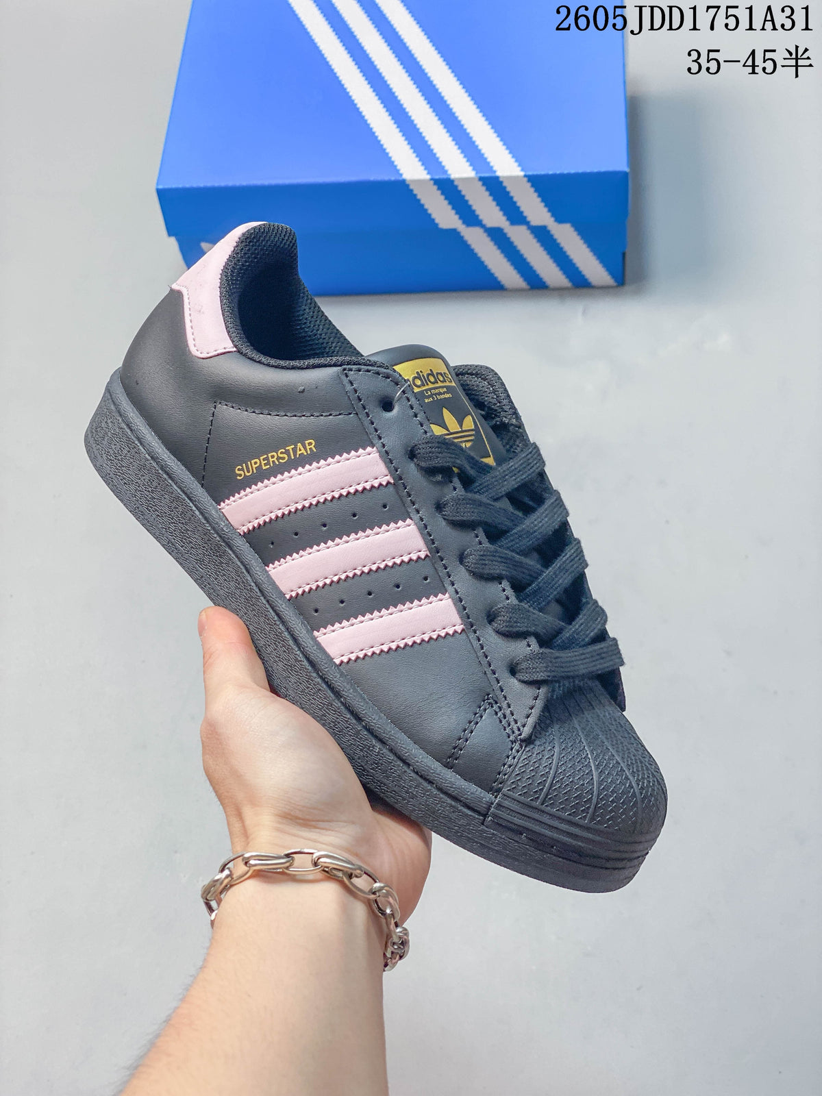Dark gray sneaker with pale pink stripes and heel accents