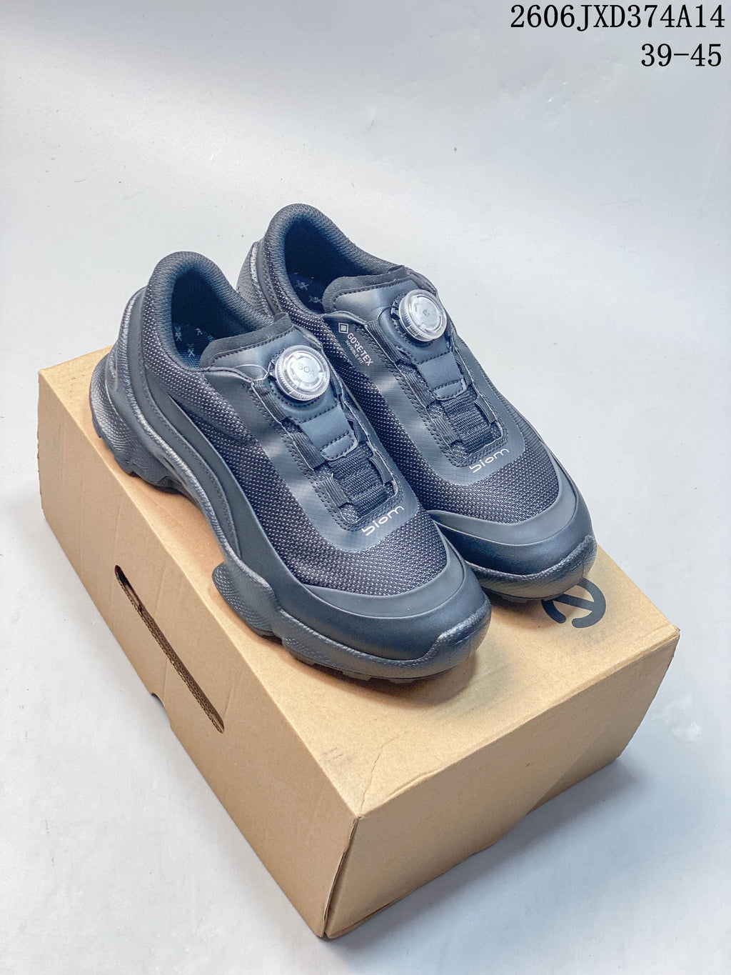 Pair of gray ECCO BIOM sneakers with dial fasteners on a box