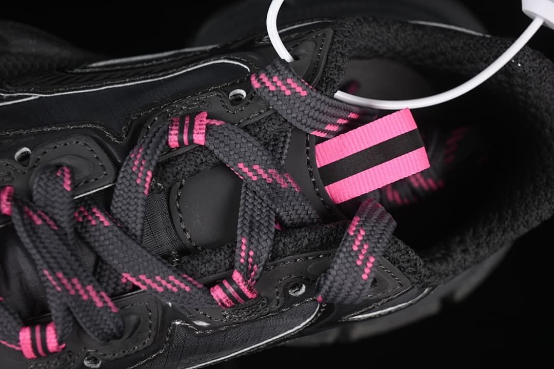 Close-up of pink-accented laces and tongue pull tab.