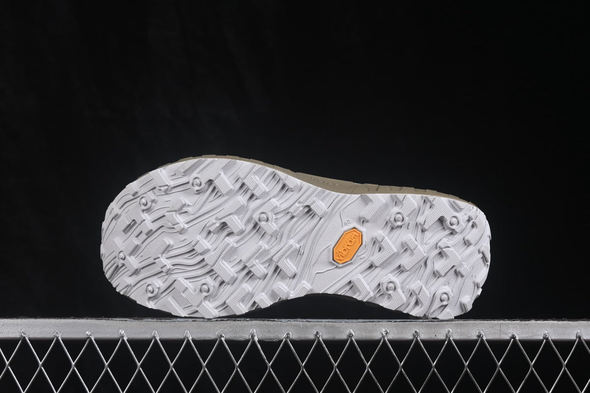 Bottom view showing the white lugged outsole with a visible Vibram mark.