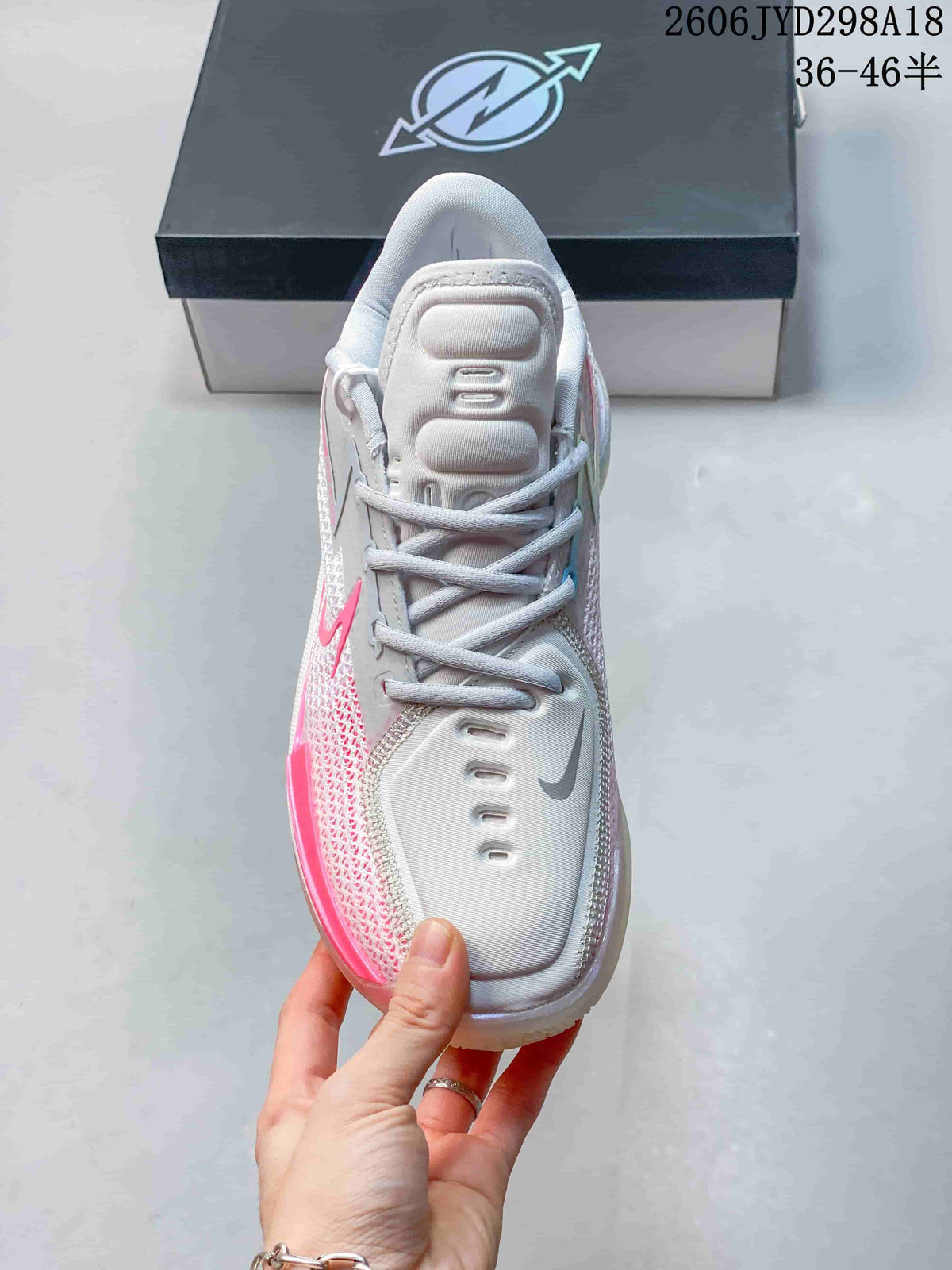 Top view showing the tongue, laces, and white and pink colorway.